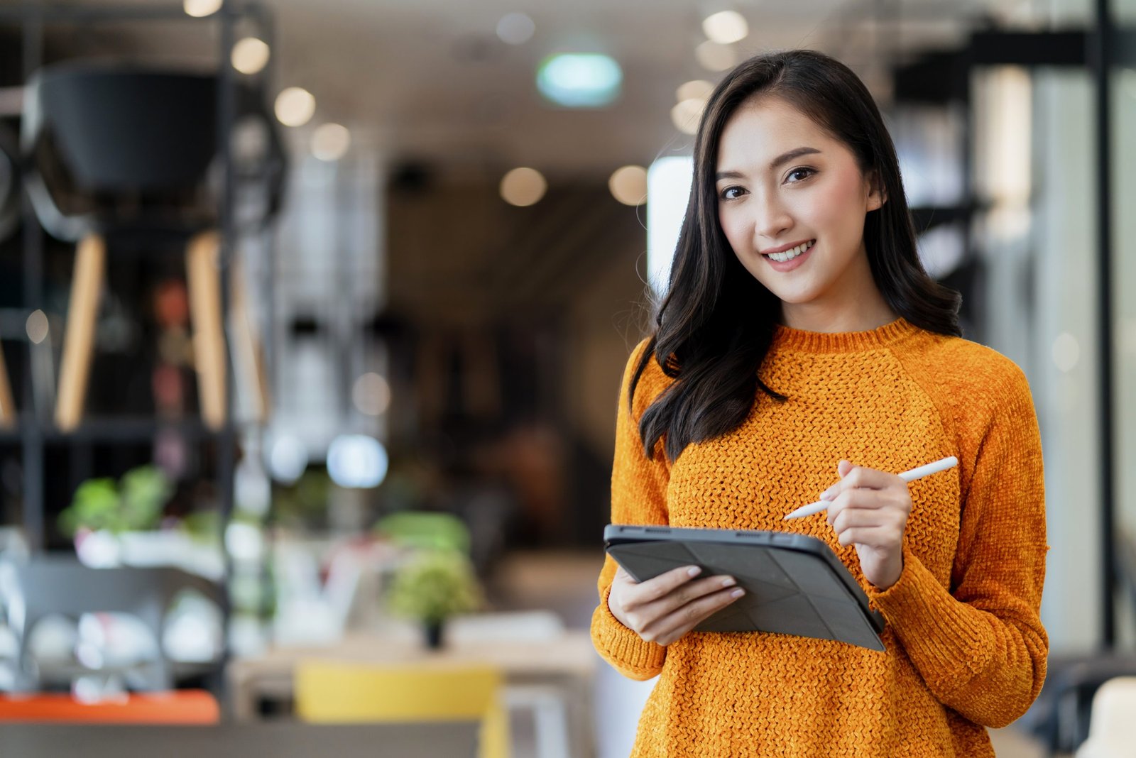 smart confidence asian female startup entrepreneur small business owner businesswoman wear smart casual cloth smile hand use tablet woking inventory checking in showroom office daytime background